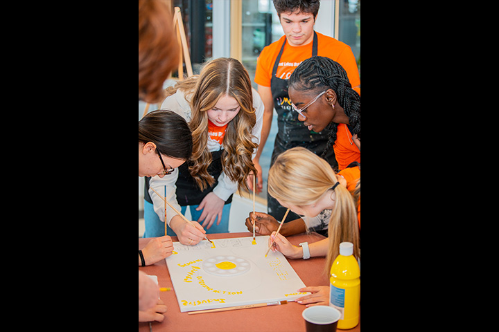 People working on a piece of art
